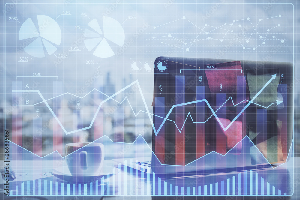 Financial chart drawing and table with computer on background. Multi exposure. Concept of international markets. Financial chart drawing and table with computer on background. Multi exposure. Concept of international markets.
