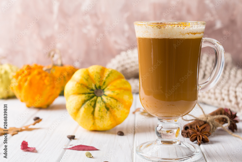 Pumpkins spice latte with pumpkins Copy space. Pumpkin latte - cozy drink for cold fall or winter Pumpkins spice latte with pumpkins Copy space. Pumpkin latte - cozy drink for cold fall or winter