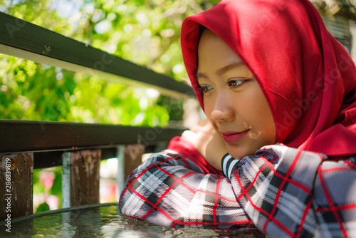 Photography lifestyle portrait of young beautiful and relaxed Asian Indonesian Muslim girl s
