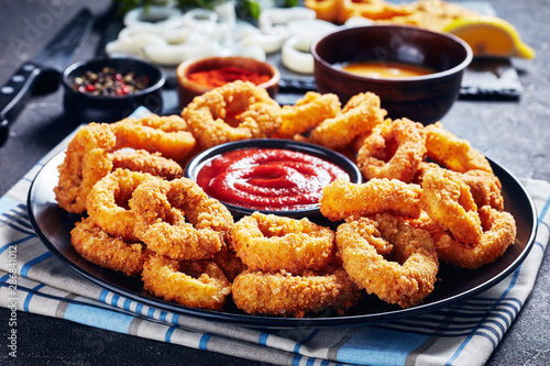 crispy calamari rings on a black plate