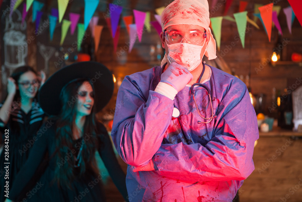 Portrait of suprised man dressed up like a doctor for halloween celebration