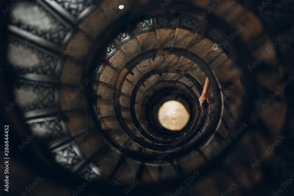 Spiral staircase and human hand