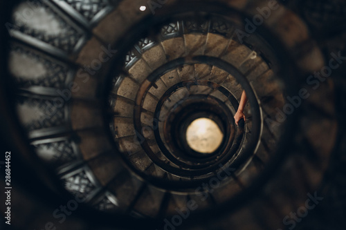 Spiral staircase and human hand