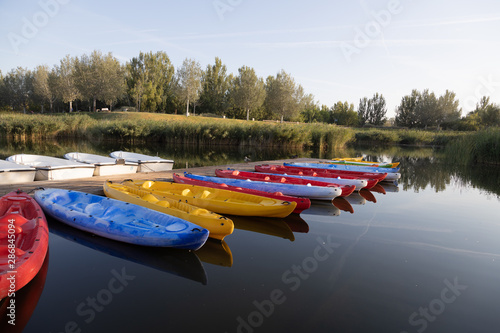jetty in pond of city of zaragoza in spain, with canoes and boats