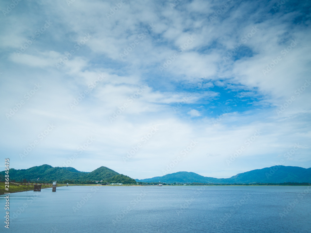 beautiful mountain, blue sky and water viewpoint of Bang Pra Reservoir, Thailand.