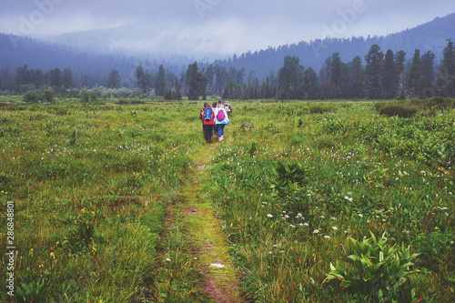 Group of hikers walking in the field in the Ergaki National park in Russia