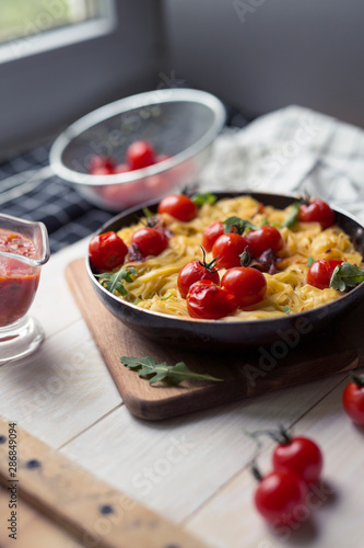 spaghetti with cherry tomatoes in a pan