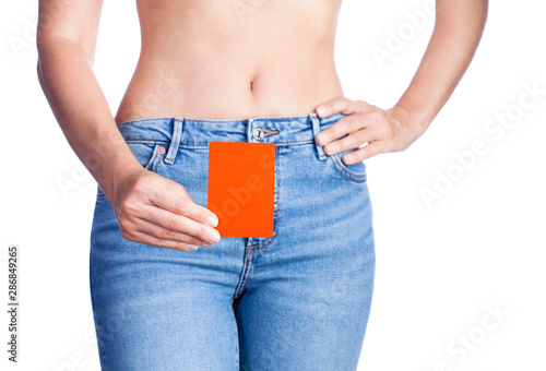 Woman holding red card at waist. photo