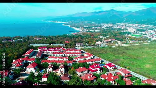 Cottage village in the resort of Kabardinka on the background of the mountains and the black sea. In the background of Markotkh mountain range and Zemesskaya Bay, see port of Novorossiysk. 4K with a d photo