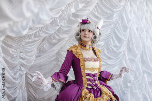 Fototapeta Girl in barocco baroque rococo old vintage dress and wig stand near white curtai