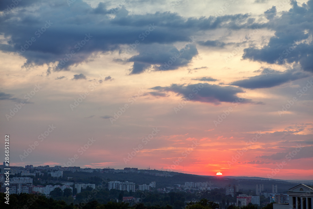 sunset and low clouds over the city