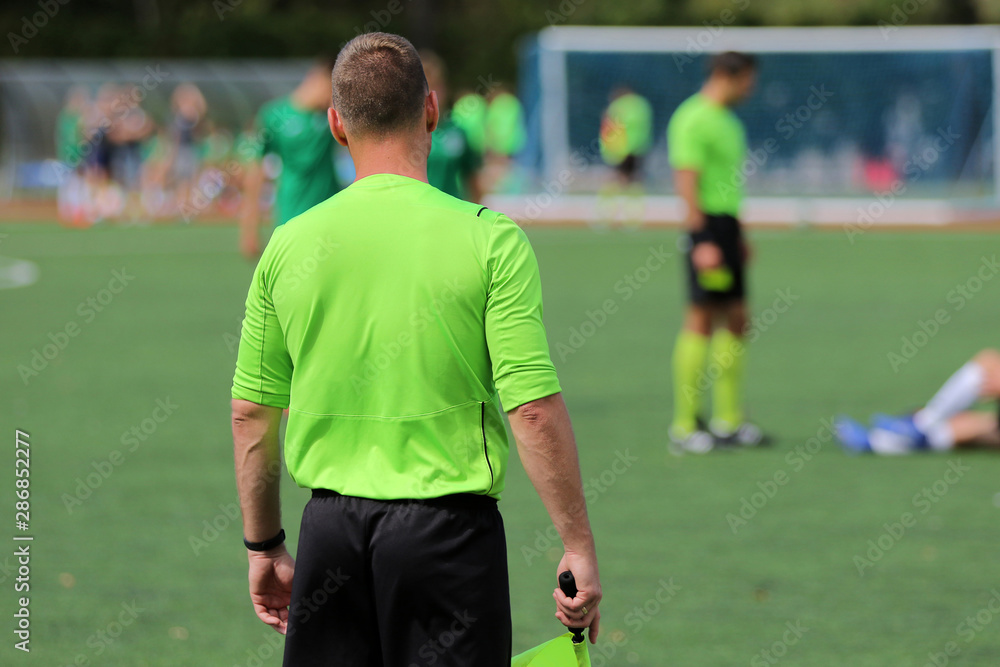 The line referee observes the situation on the football field The line referee observes the situation on the football field