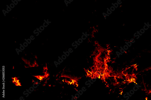 The sparkle of the flames in the dark background.