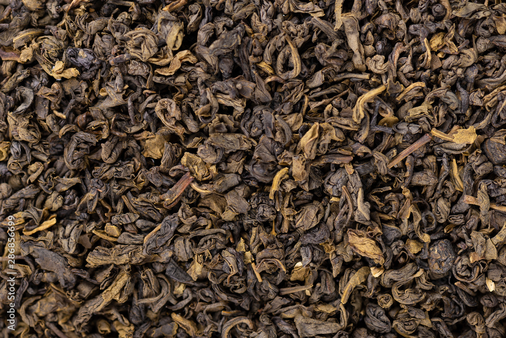 Green tea background. Aromatic green dry tea, close up.