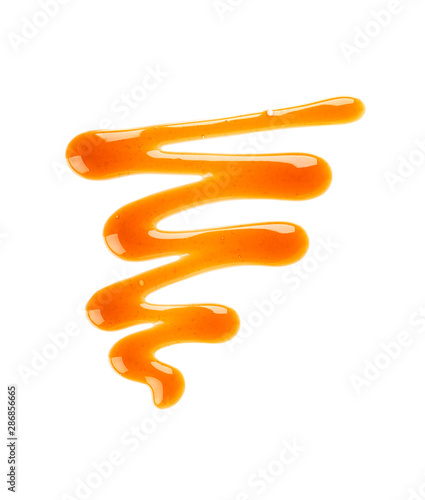 Caramel syrup drizzle isolated on white background. Splashes of sweet caramel sauce. Top view.
