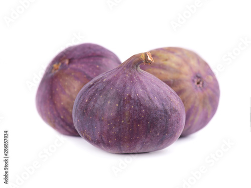 Fresh purple fig fruit isolated on white background. Whole ripe fig fruit.