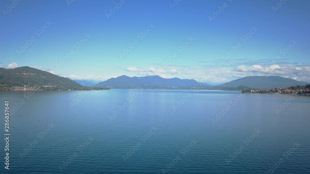 Lake Maggiore aerial shot. Fyling over the still water on a bright summer day Lake Maggiore aerial shot. Fyling over the still water on a bright summer day