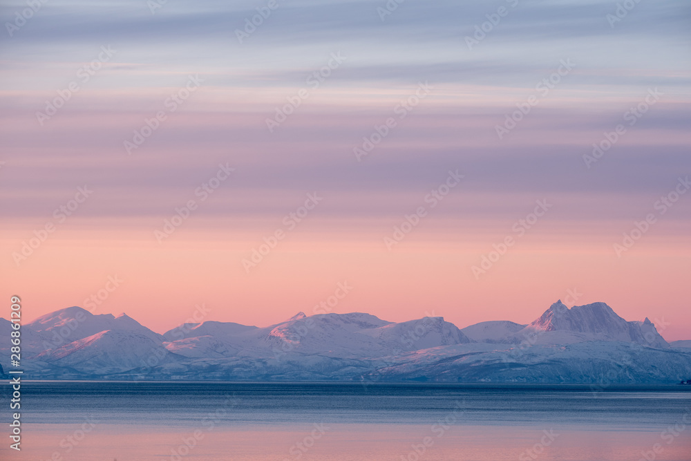 Minimalistic artic landscape under pink sky at sunset, Tromsö, Norway