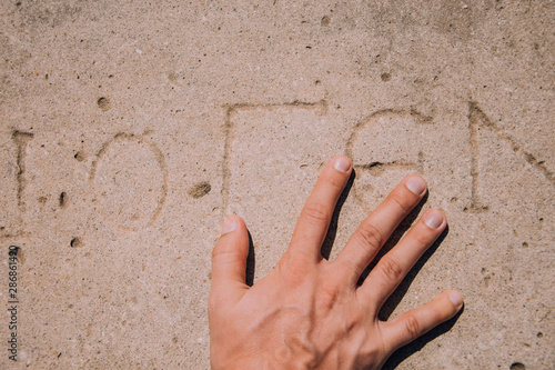 Touch of history.Male hand.Ancient inscriptions in Turkey. Excavations in historically important places. Ruins of the ancient city of Turkey. Antalya coast.Antalya Province.Pamphylia.Historical place photo