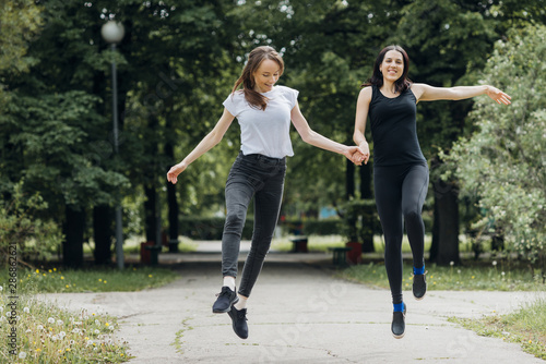 Smiling women skipping and holding hands