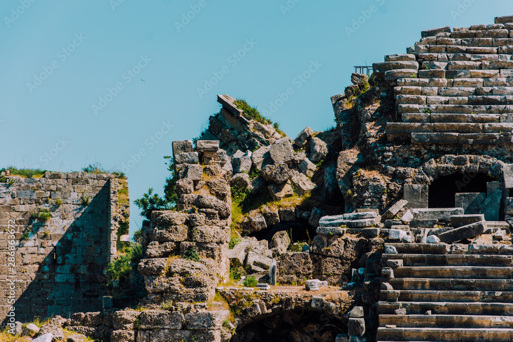 Fototapeta premium Ancient Turkish city. Side, Turkey. Remnants of the past. Antique theater.Active holidays in warm countries. Ruins of the old theatre. Antalya Province. Pamphylia.Amphitheater in Turkey