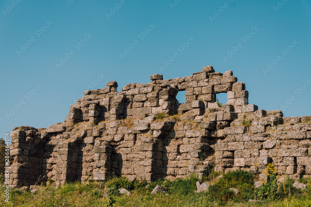 Old aqueduct in Side. Ruins of the ancient city of Turkey. Antalya coast.Antalya Province. Pamphylia. Ancient building. Historical place Old aqueduct in Side. Ruins of the ancient city of Turkey. Antalya coast.Antalya Province. Pamphylia. Ancient building. Historical place
