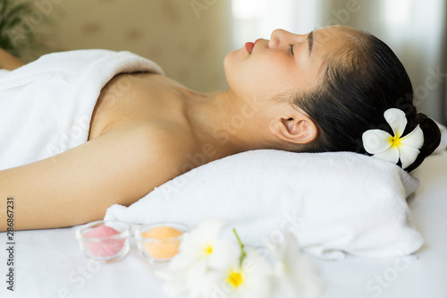 Beautiful young Asian woman spa massage while relax in spa salon center hotel. wellness  woman and beauty concept
