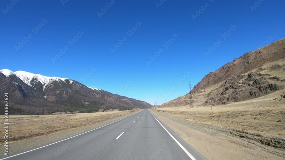 Driving along mountain asphalt road Chuysky Tract along Kurai Ridge on Altai betveen Kosh-Agach and Kurai intermountain hollows Driving along mountain asphalt road Chuysky Tract along Kurai Ridge on Altai betveen Kosh-Agach and Kurai intermountain hollows