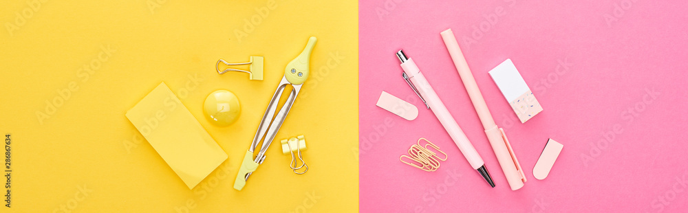Panoramic shot of different yellow and pink stationery on bicolor background Panoramic shot of different yellow and pink stationery on bicolor background