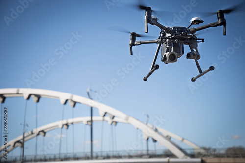 Fototapeta Naklejka Na Ścianę i Meble -  Drone in air near a bridge and energy objects