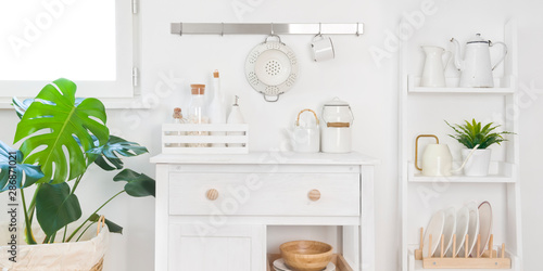 Refined kitchen cabinet with various utensils. Storage and organizing concept © didecs