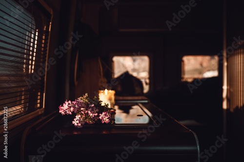 Blumenstraus und Kerze in einem Campervan  photo