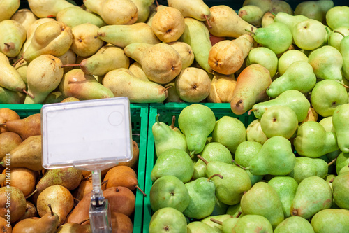 pears at the grocery store. lots of pears harvest collected in bins at production stage.