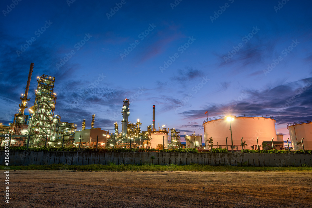 Industrial view Oil refinery and oil tanks plant during at sunrise