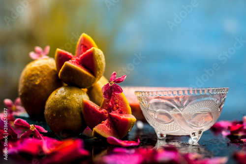 Guava face mask for glowing skin on a wooden surface with a blurred background consisting of some guava pulp well mixed with water. photo