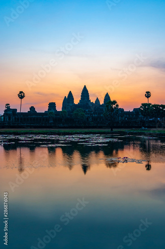 Vertical photograph of the Khmer archaeology complex of Angkor Wat at sunrise, Siem Reap, Cambodia.