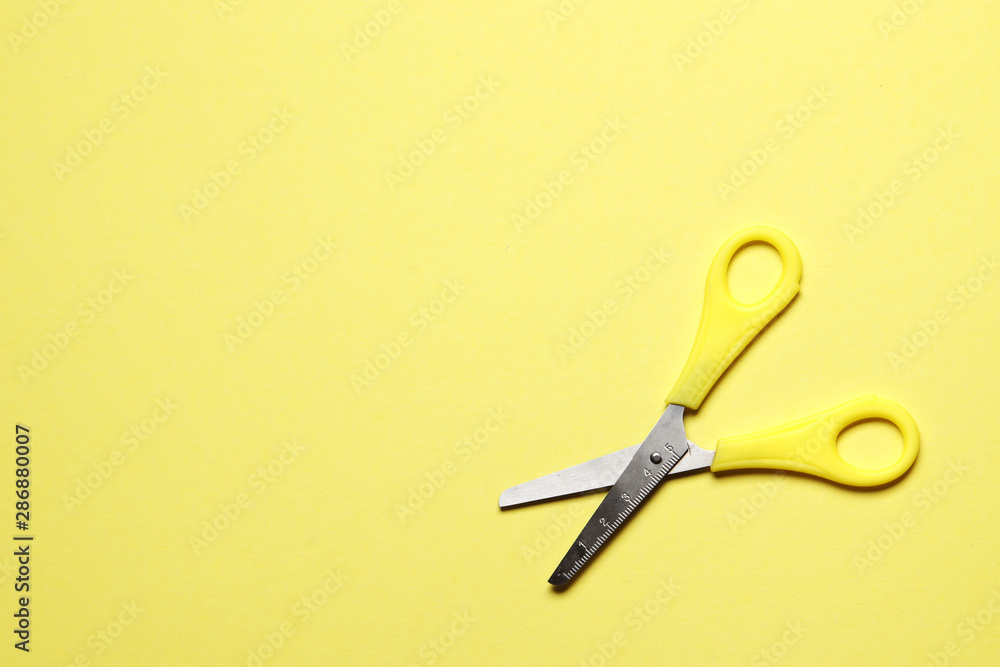 Yellow scissors on a yellow background with place for text Yellow scissors on a yellow background with place for text