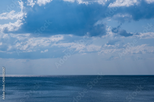 clear blue sea with beautiful sky with white clouds © Marina Gordejeva