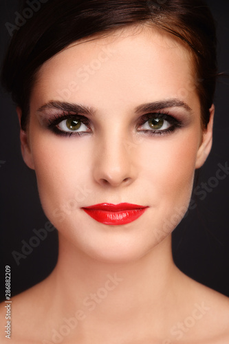 Portrait of young beautiful woman with red lipstick