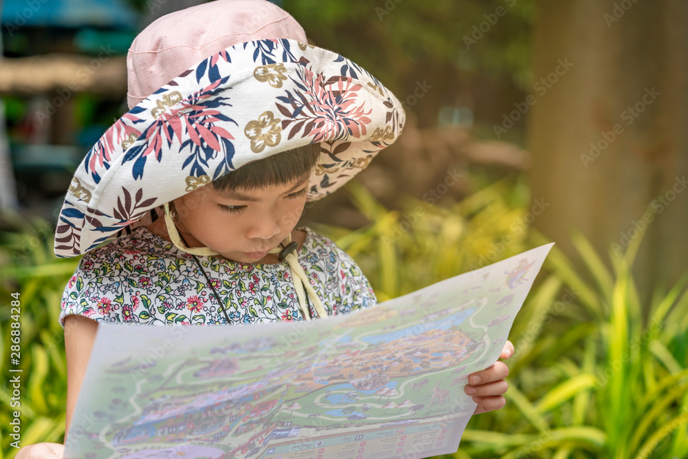 © dul_ny - Little Asian girl is holding map © dul_ny - Little Asian girl is holding map