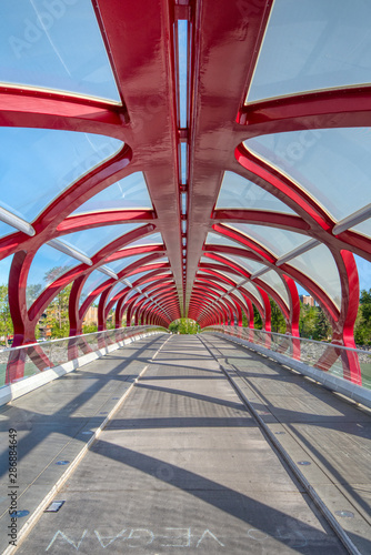 A modern bridge constructed of metal traverses alrge river in Canada  photo