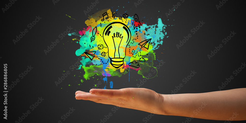 Elegant hand holding lighting bulb in his hand, new idea concept Elegant hand holding lighting bulb in his hand, new idea concept