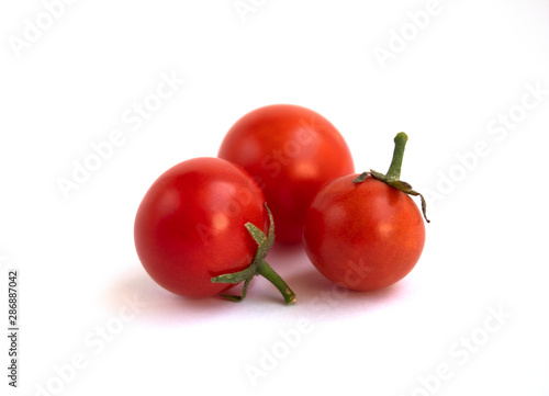Tomatoes and grapes. Close-up. Isolated on a gray background. There is a place for text.