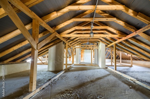 Attic of a building with wooden beams of a roof structure.