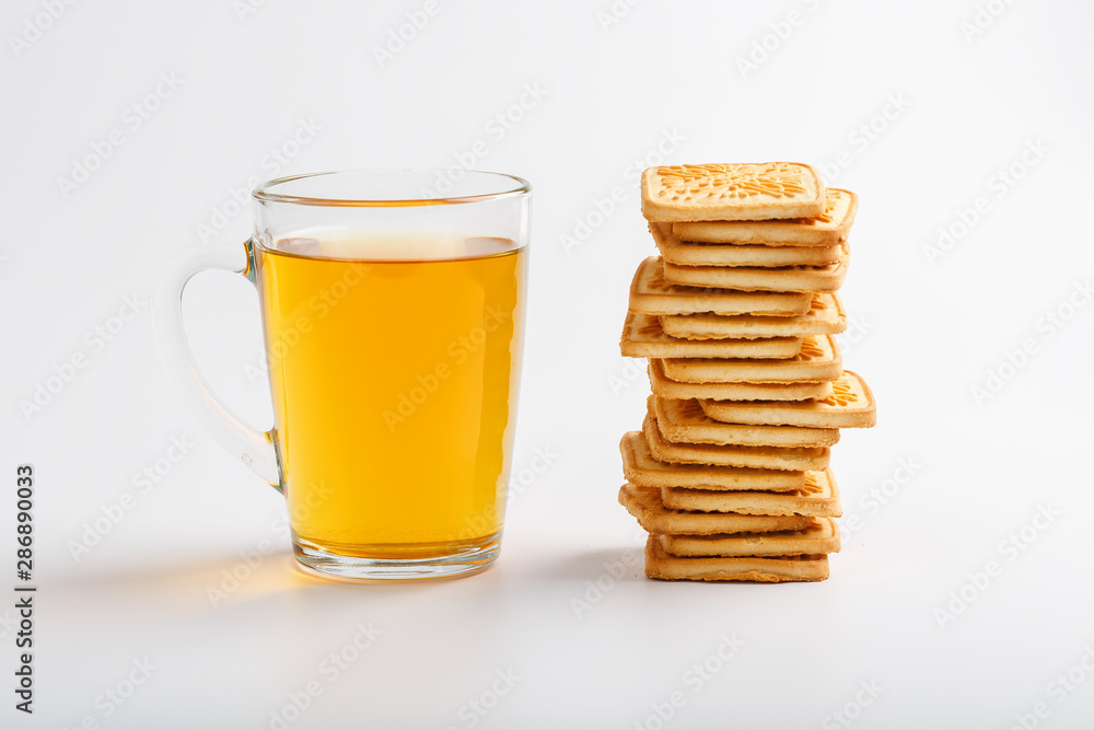 Mug of green tea and wheat cookies on a light background. Breakfast Cookies. Close up Mug of green tea and wheat cookies on a light background. Breakfast Cookies. Close up