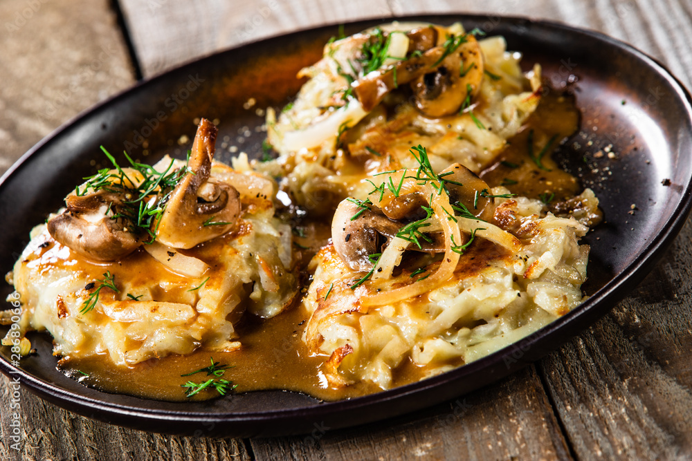 Potato cakes with gravy sauce and champignon Potato cakes with gravy sauce and champignon
