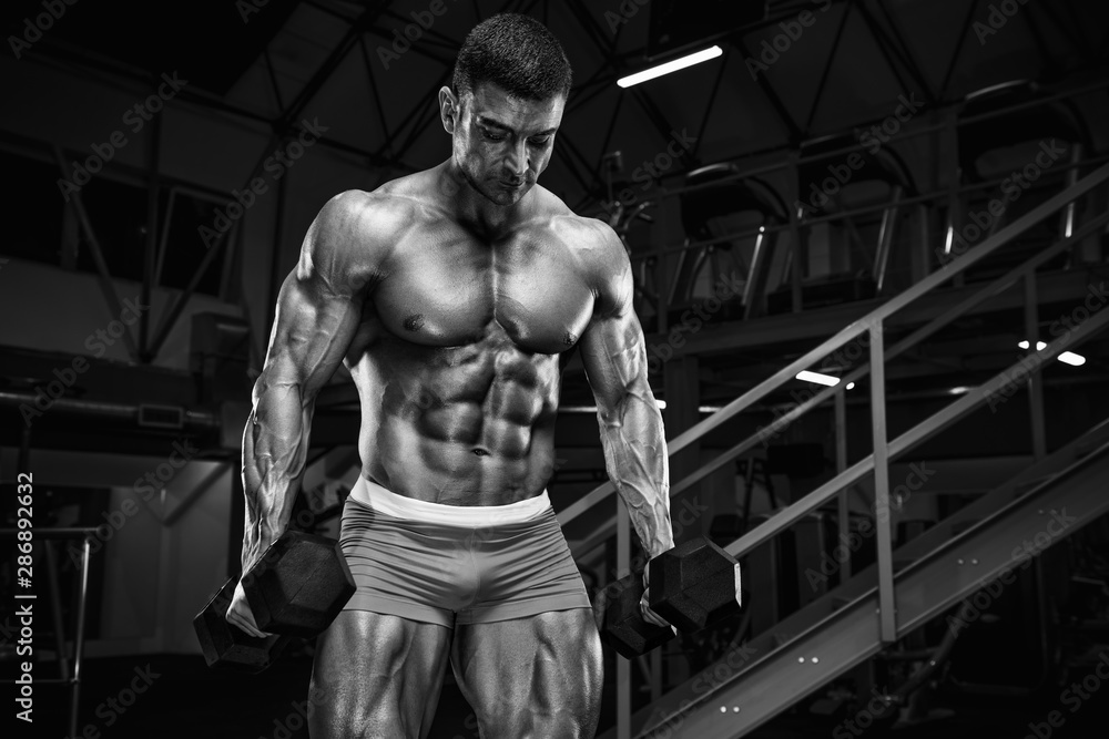 Bodybuilder Workout in the Gym, doing Biceps Exercise.Black and White Image