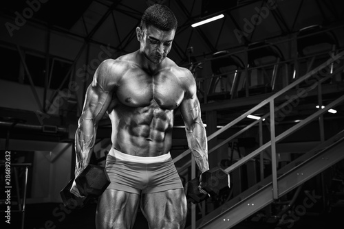 Bodybuilder Workout in the Gym  doing Biceps Exercise.Black and White Image