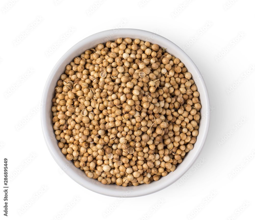 Coriander seeds in white bowl isolated on white background. top view