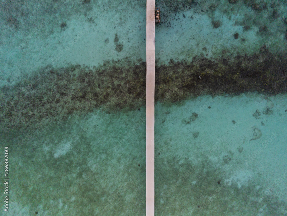 Jetty for boats in a Maldivian atoll seen from above - aerial view Jetty for boats in a Maldivian atoll seen from above - aerial view